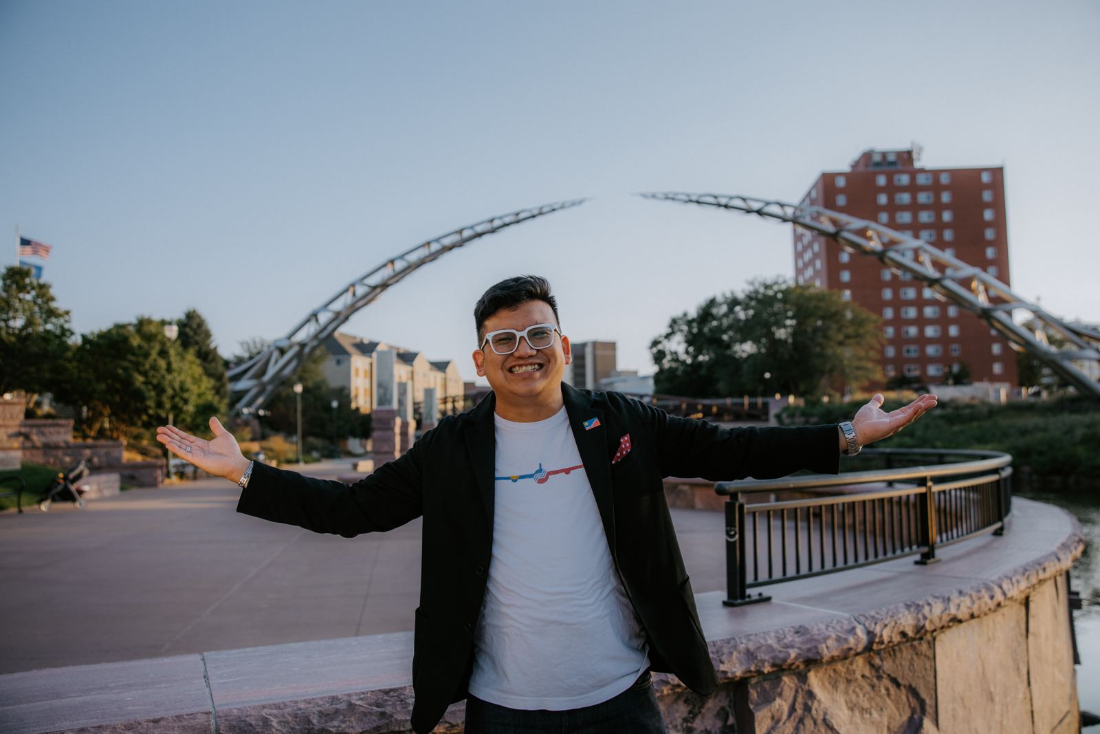 Vince Danh with arms wide open in front of the Arc of Dreams in downtown Sioux Falls